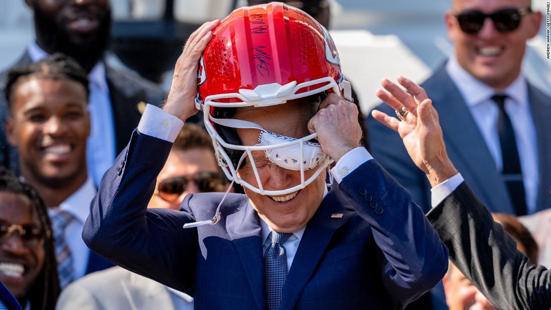 Biden puts on a Kansas City Chiefs football helmet as he welcomes the Super Bowl champions to the White House on Friday, May 31.