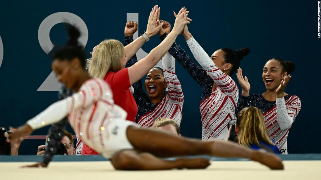 Team USA celebrates as Biles finishes her floor exercise in the Olympic team competition.