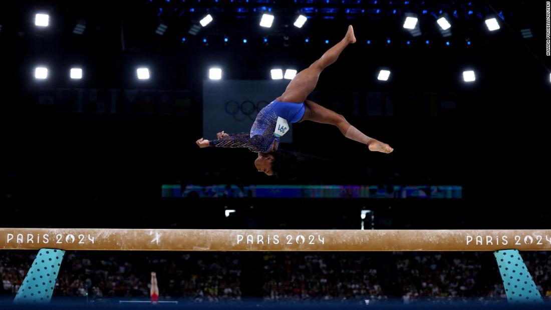 Simone Biles competes on the balance beam during the individual all-around at the Paris Olympics in August 2024. She won gold.