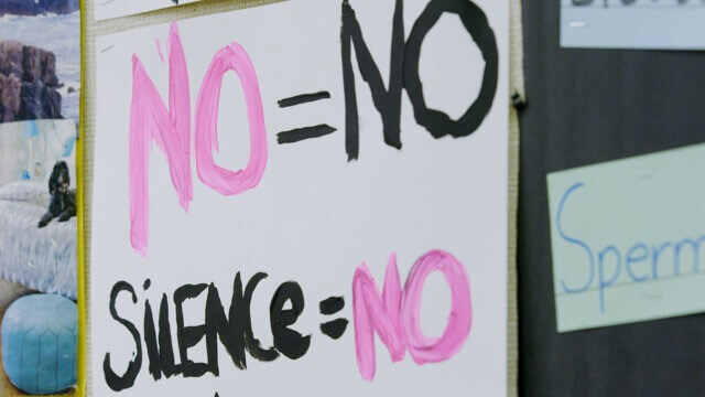A handmade sign about consent hangs in Leticia Jenkins' classroom.